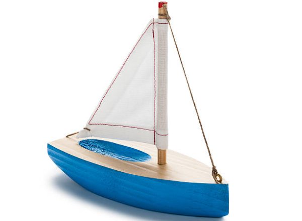 Blue toy sailboat, isolated on white.